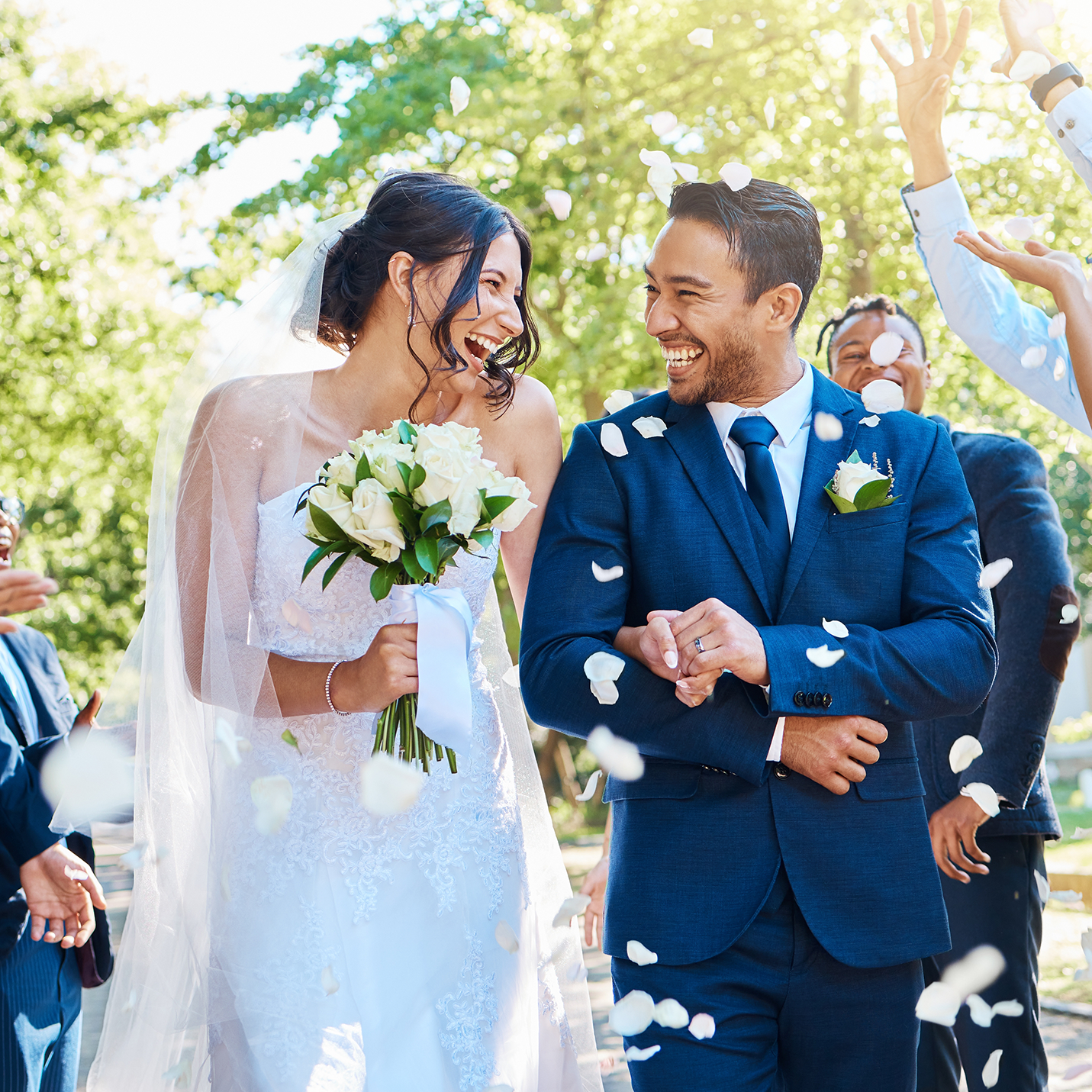 Happy, wedding ceremony and couple walking with petals and guests throw in celebration of romance.