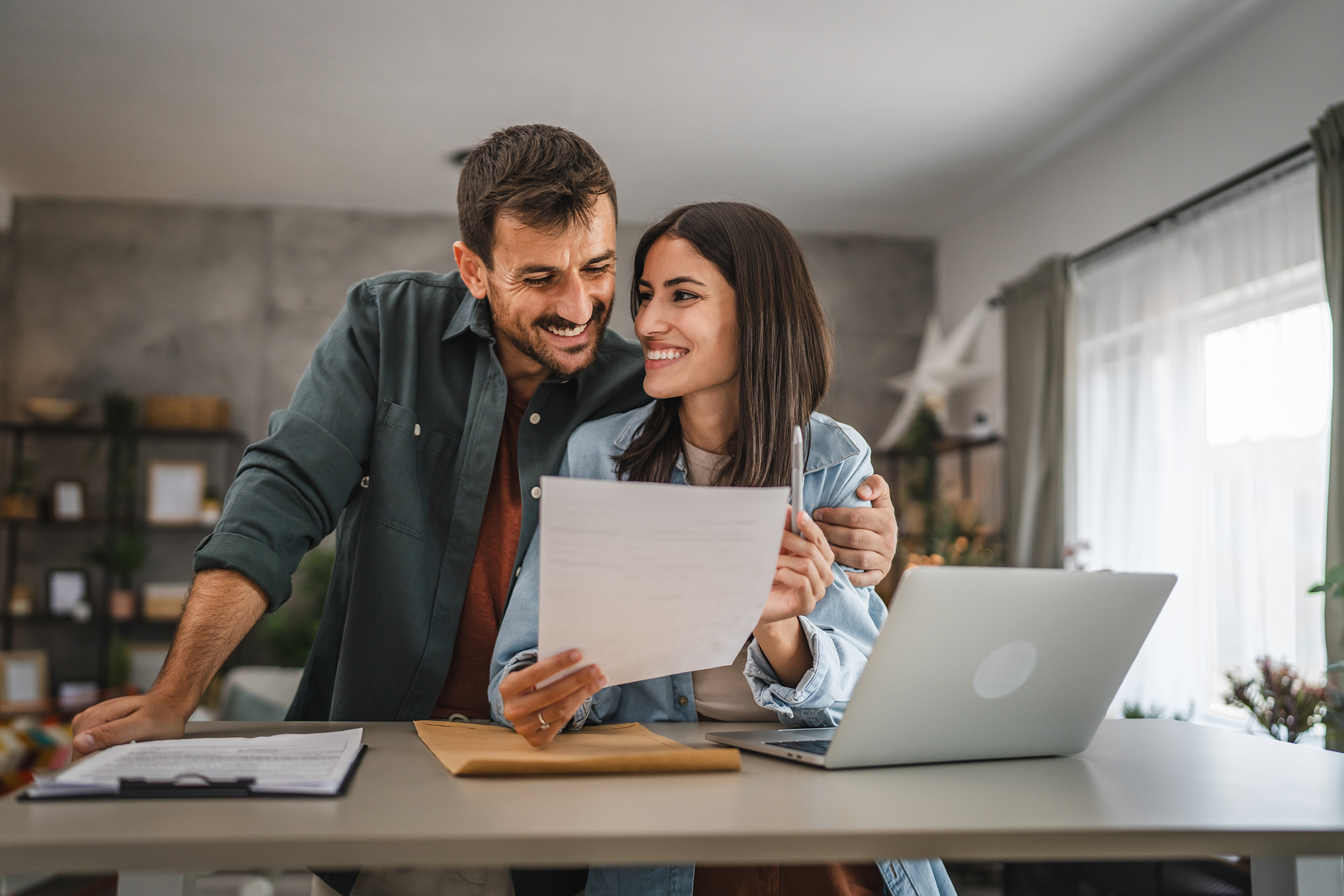 Couple boyfriend and girlfriend read together letter from envelope.