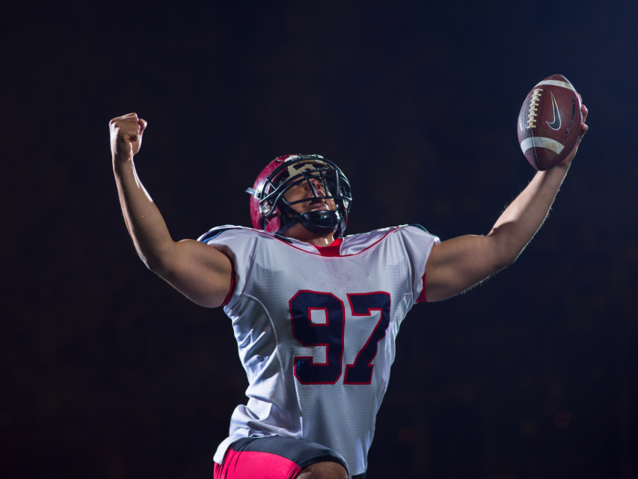 Football player celebrations touchdown on the field.