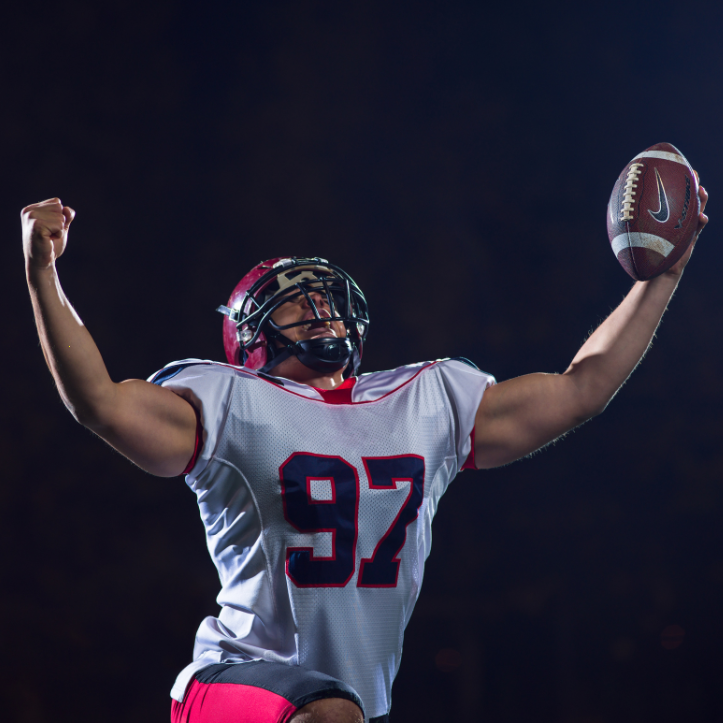 Football player celebrations touchdown on the field.